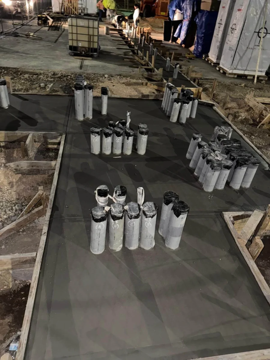 underground utility lines installed at night before concrete slab in commercial construction project